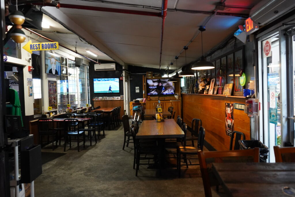 Inside Ferg’s Sports Bar in St. Pete FL with bar seating and multiple TVs